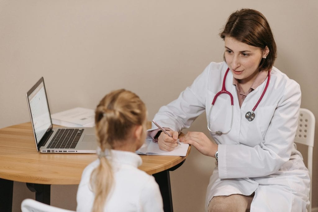 A doctor talking to a little patient
